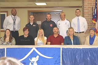Chillicothe High standout Kasey Crow poses with family, coaches and administrators after signing to play at Rio Grande